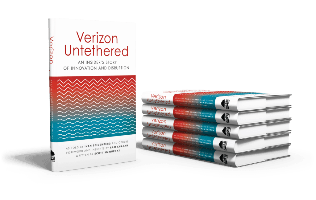 This is a photograph of a stack of company history books titled 'Verizon Untethered: An Insider's Story of Innovation and Disruption'.