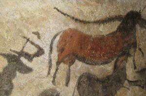 This is a photograph of ancient cave paintings. It shows a herd of horses.