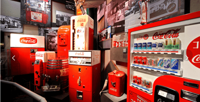 Pictured: historical Coca-Cola merchandise and vending machines. These are artifacts in the company archive.